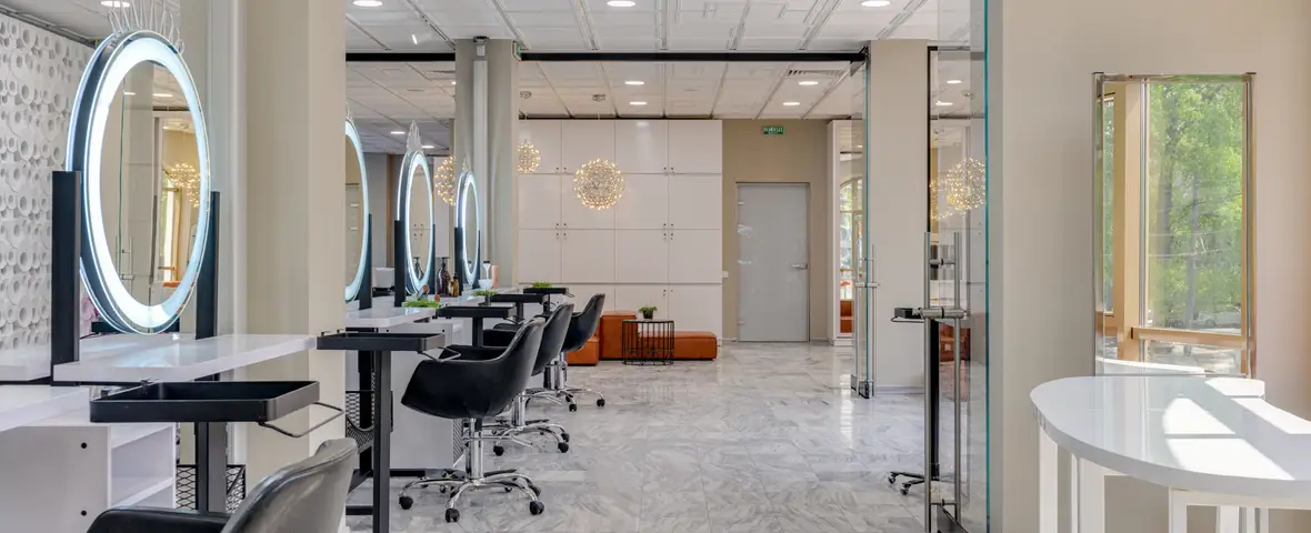 A bright, boutique hair salon interior with styling stations